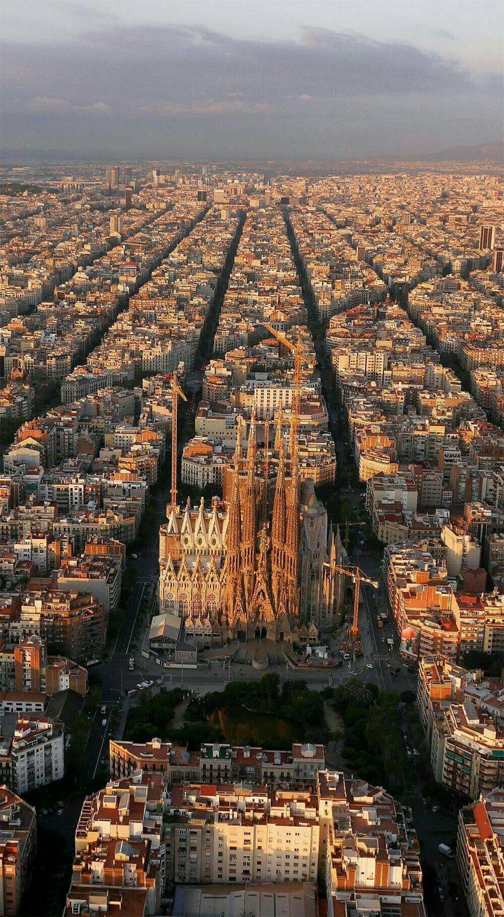 Aerial view of the Eixample at sunrise, with the Sagrada Família among the city blocks
